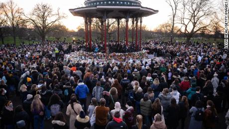 People gather to pay their respects at a vigil on Clapham Common, where floral tributes have been placed for Sarah Everard on March 13, 2021 in London, England.