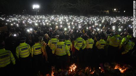 Police officers form a cordon around the Clapham Common bandstand in south London on March 13, 2021, where people had gathered for the Sarah Everard vigil.