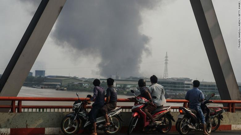 Smoke rises as protests against military coup and detention of elected government members continue in Hlaingtharya Township, Yangon, on March 14.