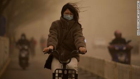 A woman walks down a street during a sandstorm in Beijing on March 15th.