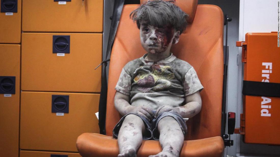 This still image, taken from a video posted by the Aleppo Media Center, shows a young boy in an ambulance after an airstrike in Aleppo, Syria, on August 17, 2016. It took nearly an hour to dig the boy, identified as Omran Daqneesh, out from the rubble, an activist told CNN. The airstrike destroyed his home, where he lived with his parents and two siblings. Director of the Aleppo Media Center Yousef Saddiq said Omran&#39;s 10-year-old brother, Ali, died from his injuries.