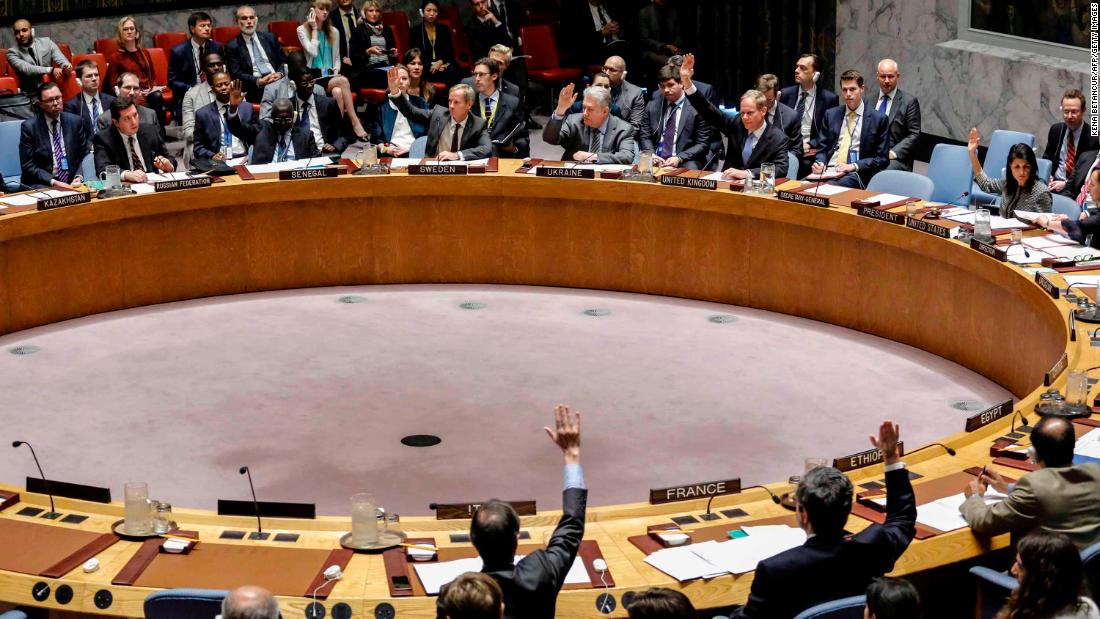 Members of the UN Security Council raise their hands on April 12, 2017, as they vote in favor of a draft resolution that condemned the reported use of chemical weapons in Syria.