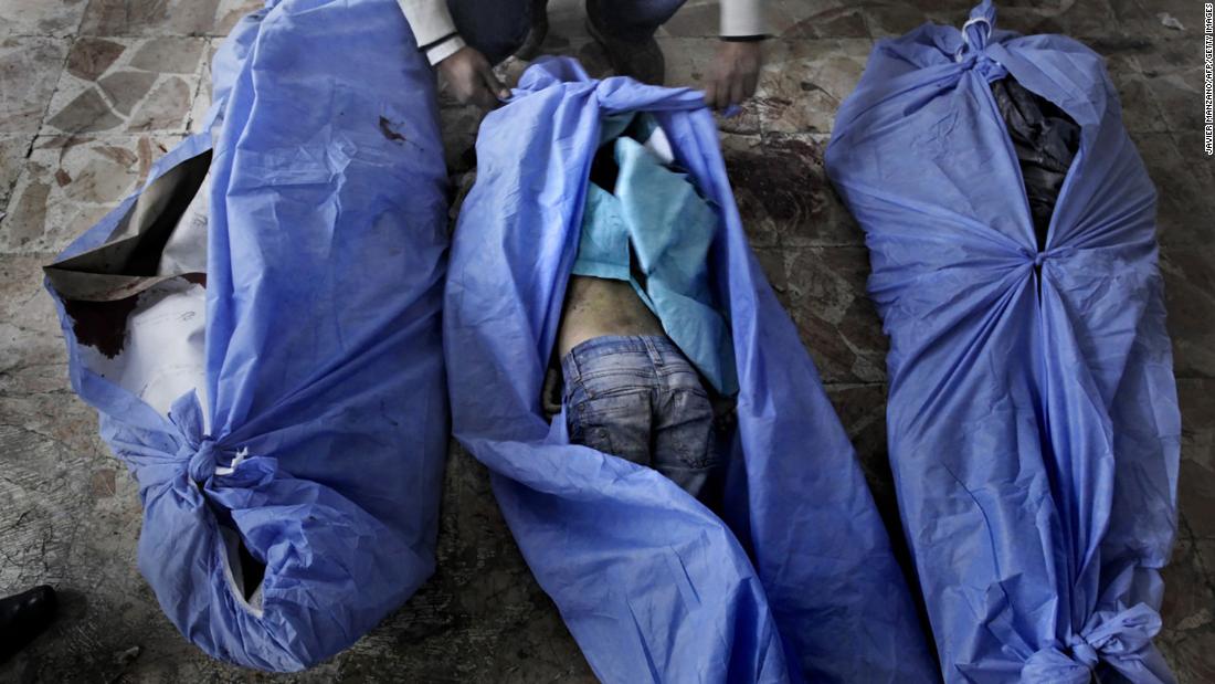 The bodies of three children are laid out for identification by family members at a makeshift hospital in Aleppo on December 2, 2012. The children were allegedly killed in a mortar shell attack that landed close to a bakery in the city.