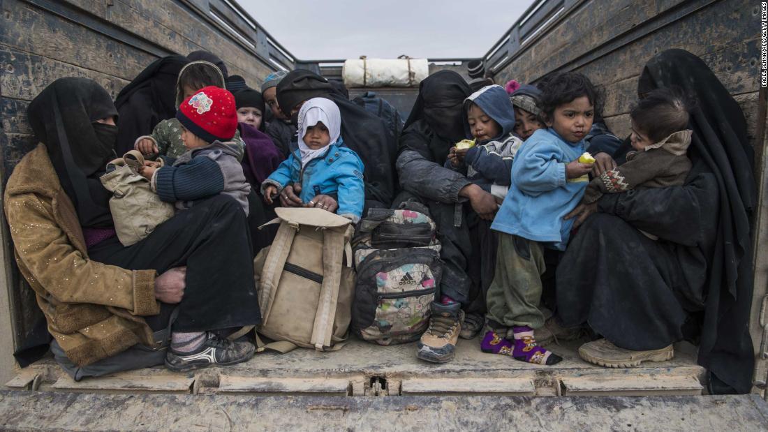 Women and children who fled the Islamic State group&#39;s embattled holdout of Baghouz wait in the back of a truck in the eastern Syrian province of Deir Ezzor, on February 14, 2019.