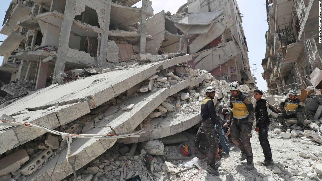 Members of the Syrian Civil Defence, also known as the &quot;White Helmets,&quot; search the rubble of a collapsed building following an explosion in the town of Jisr al-Shughur on April 24, 2019.