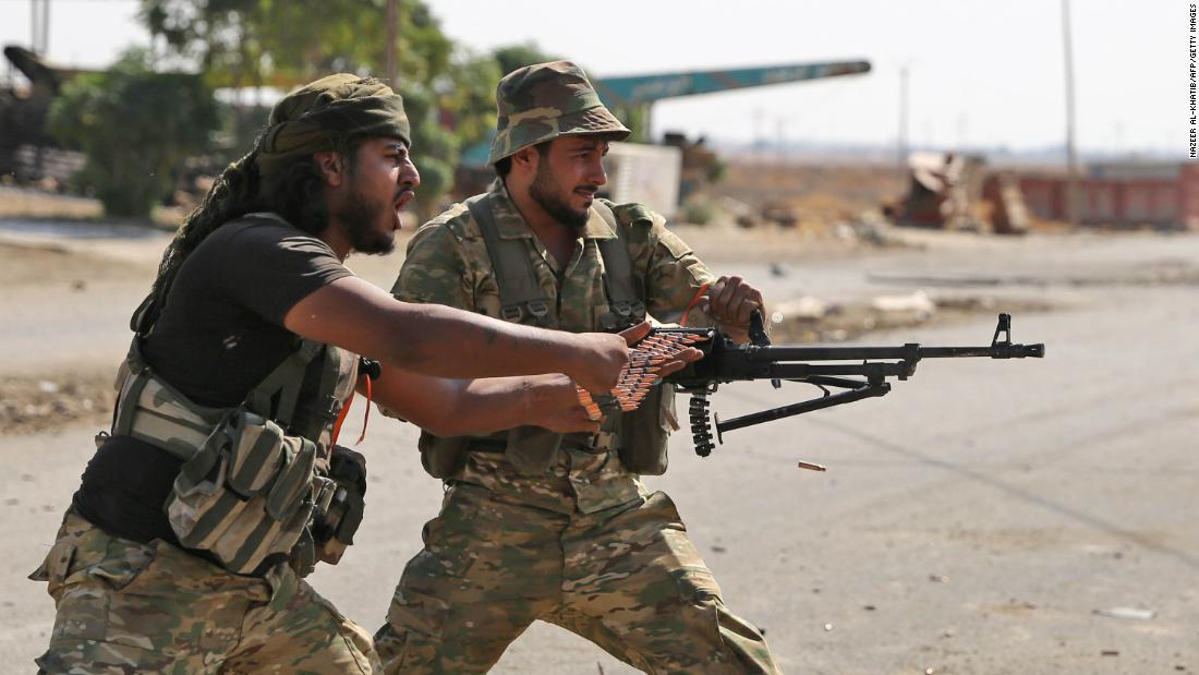 Turkish-backed Syrian fighters take part in a battle in Syria&#39;s northeastern town of Ras al-Ain as Turkey and its allies continue their assault on Kurdish-held border towns in northeastern Syria on October 14, 2019.