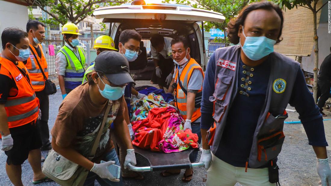 Emergency workers transport the body of Shel Ye Win, who was shot by security forces in Mandalay.