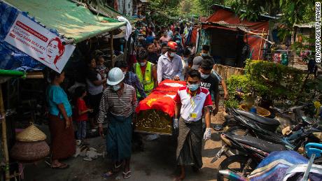 Pallbearers carry the coffin of Ye Swe Oo, who was shot and killed on March 13 during a crackdown by security forces on protesters demonstrating against the military coup, in Mandalay on March 14.