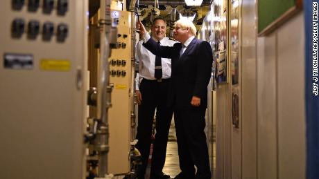 Commander Justin Codd, left, chats with British Prime Minister Boris Johnson aboard Vanguard-class submarine HMS Victorious during a visit to the Faslane naval base north of Glasgow, Scotland on July 29, 2019.