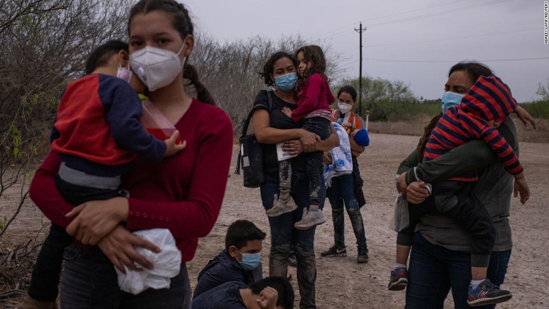 Migrant mothers from Central America hold their children as they await transport after crossing from Mexico into La Joya, Texas, on March 14.