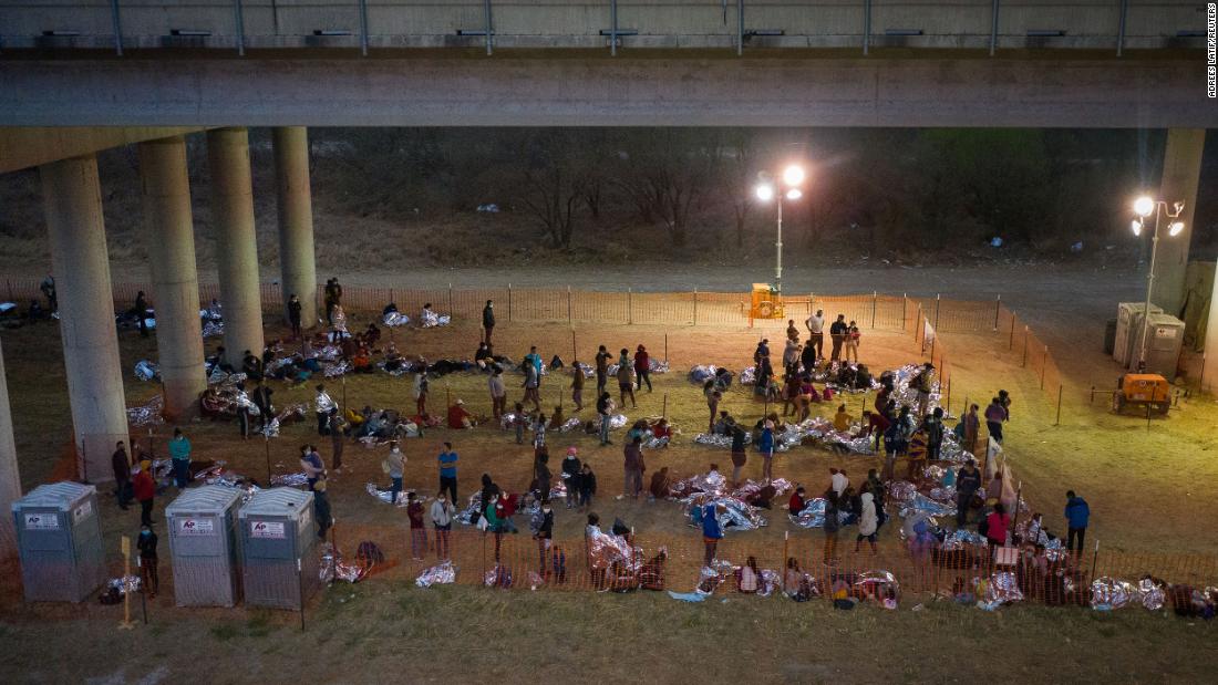 Migrant families and unaccompanied minors from Central America take refuge in a makeshift processing center under the Anzalduas International Bridge in Granjeno, Texas, on March 12.