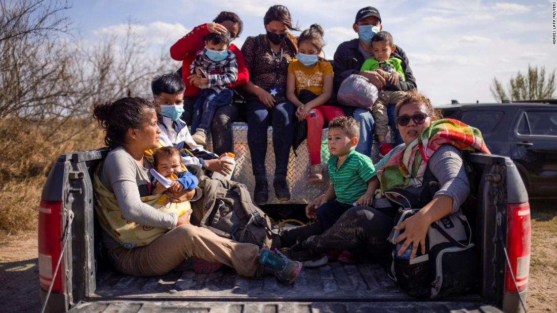 Migrant families and children sit in the back of a police truck after they crossed the Rio Grande on March 5.