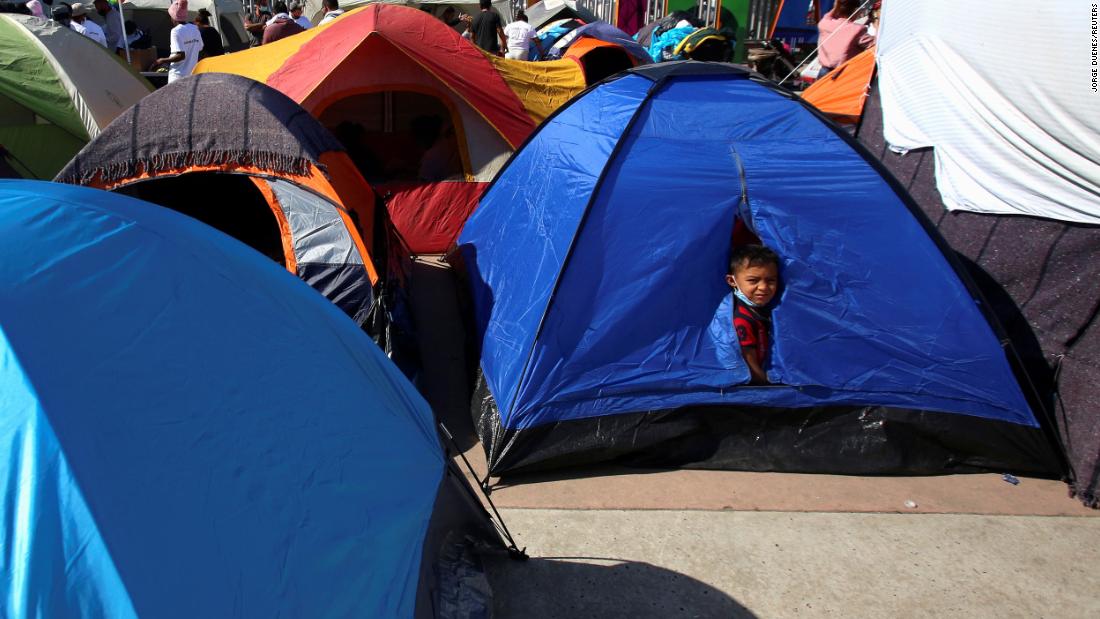 A child looks out from a tent in Tijuana, Mexico, on February 27. He&#39;s camped next to other migrants from Central America who are hoping to cross the border and request asylum in the United States.