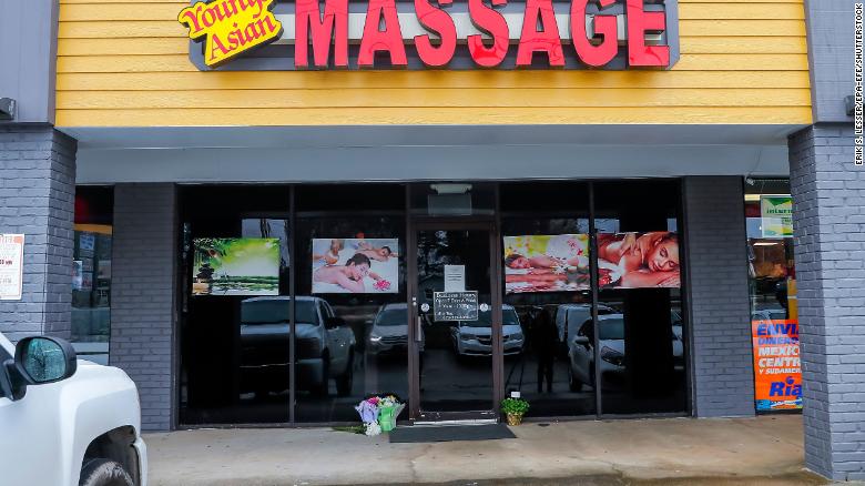 Flowers left by well-wishers sit at the entrance to Young&#39;s Asian Massage spa in Acworth, Georgia, on March 17.
