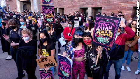 Demonstrators wearing face masks and holding signs take part in a rally &quot;Love Our Communities: Build Collective Power&quot; to raise awareness of anti-Asian violence in Los Angeles on March 13.