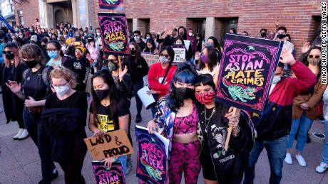 Demonstrators wearing face masks and holding signs take part in a rally &quot;Love Our Communities: Build Collective Power&quot; to raise awareness of anti-Asian violence, at the Japanese American National Museum in Little Tokyo in Los Angeles, California, on March 13, 2021.