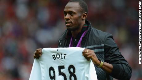MANCHESTER, ENGLAND - AUGUST 25:  Jamaican Athlete Usain Bolt poses with a United shirt prior to the Barclays Premier League match between Manchester United and Fulham at Old Trafford on August 25, 2012 in Manchester, England.  (Photo by Shaun Botterill/Getty Images)