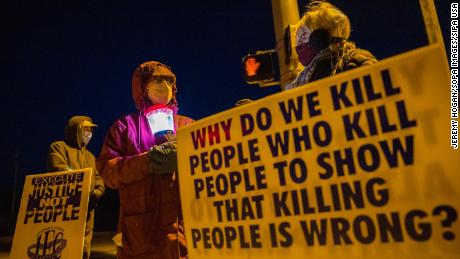 Bloomington anti-death-penalty activist Glenda Breeden holds a lamp while protesting against the execution of Lisa Montgomery, and two on January 12, 2021.