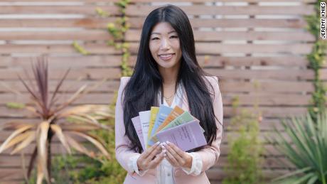 Esther Lim holding her &quot;How to Report a Hate Crime&quot; booklets.