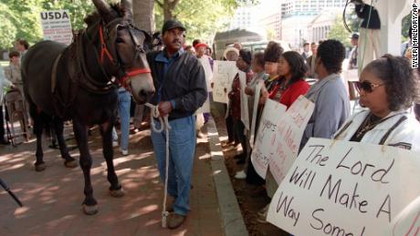 John Boyd Sr. and his mule Struggle walk among the crowd during a rally in Lafayette Park across from the White House Monday Sept. 22, 1997 to protest discrimination against Black Farmers by the Agriculture Department. 