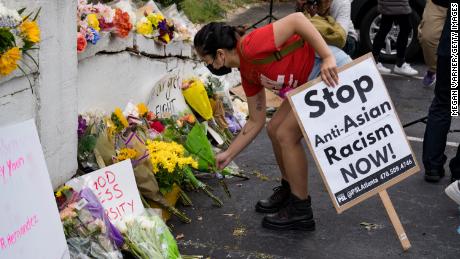 Activists leave flowers during a demonstration against violence against women and Asians on March 18, 2021 in Atlanta.