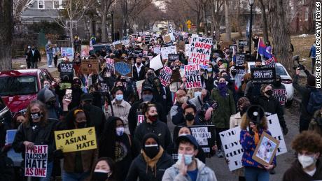 People march through a neighborhood in Minneapolis, Minnesota, on March 18, 2021, to protest anti-Asian violence. 