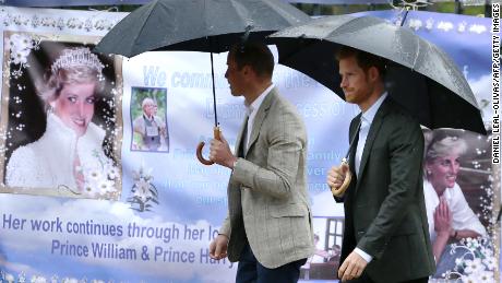 William, left, and Harry look at tributes left outside Kensington Palace to mark the 20th anniversary of Diana&#39;s death in 2017.