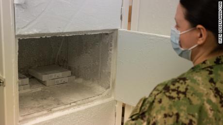 Lt. Jennifer M. White opens the freezer used to store the Pfizer vaccine at Portsmouth Naval Medical Center on March 15th.