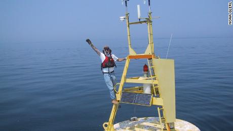 Mike McCormick, a co-author on the new study, stands on a buoy in Lake Michigan in 1999.