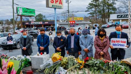 Members of the Atlanta Korean American Committee Against Asian Hate Crime hold a remembrance vigil at the scene of two of the massage parlor shootings in Atlanta.