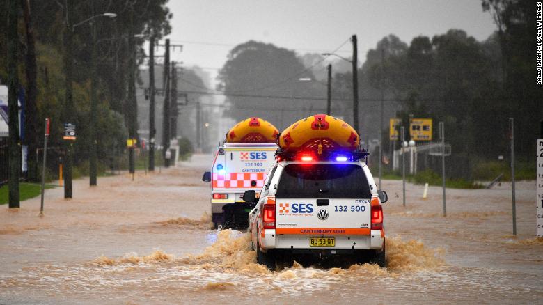 Emergency rescue vehicles drive through flooded parts of western Sydney, Australia, on March 20.