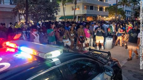 Miami Beach Police Department officers enforce an 8 p.m. curfew on Saturday night.