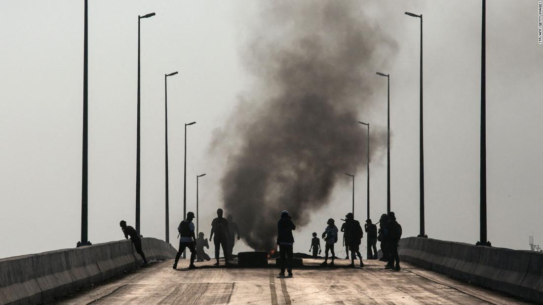 Protesters stand near burning tires in Yangon on March 16.