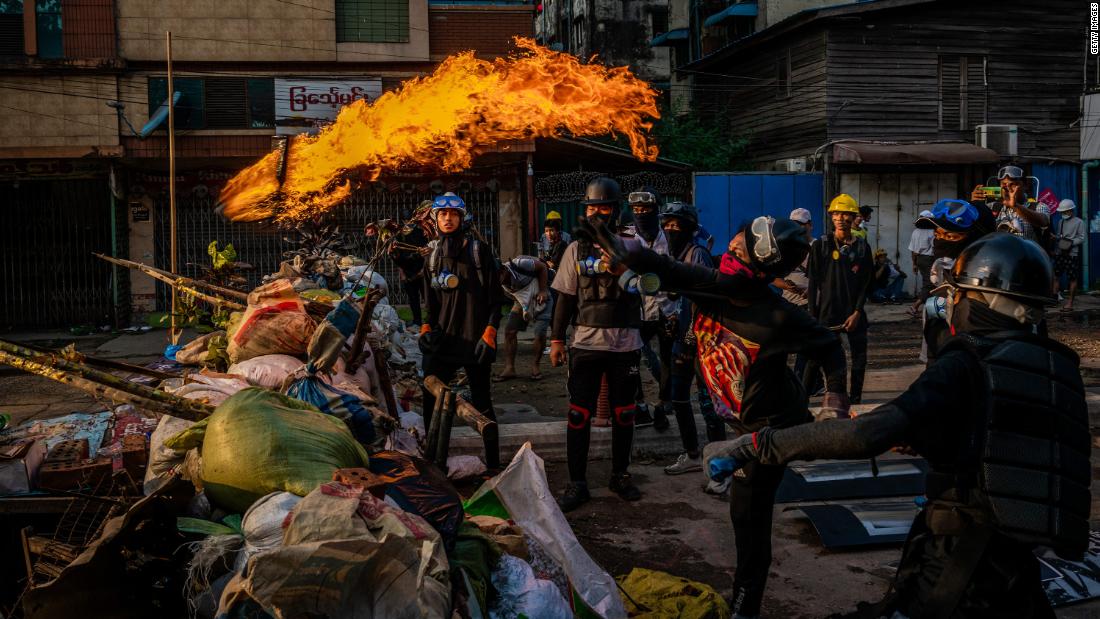 Protesters test Molotov cocktails in Yangon on March 16.