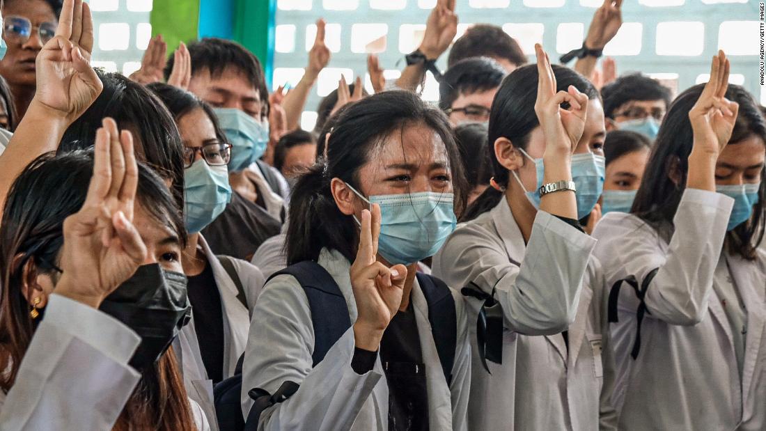 Medical students hold up the &lt;a href=&quot;https://www.cnn.com/2014/11/20/world/asia/thailand-hunger-games-salute/index.html&quot; target=&quot;_blank&quot;&gt;three-finger salute&lt;/a&gt; at the Yangon funeral of Khant Nyar Hein on Tuesday, March 16. The first-year medical student was fatally shot during the crackdown.