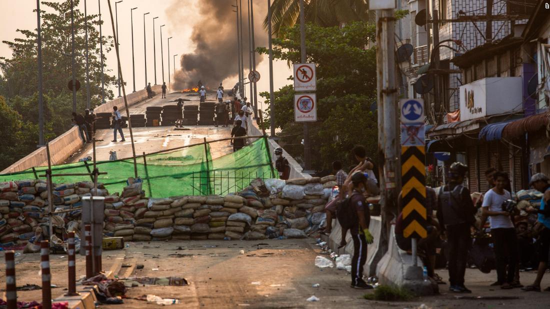 Protesters take positions on Yangon&#39;s Bayint Naung Bridge on Wednesday, March 17. The bridge was blocked with an improvised barricade to prevent security forces from crossing.