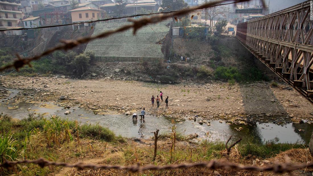 Unidentified people cross the Tiau River at the India-Myanmar border on Saturday, March 20. Some people from Myanmar &lt;a href=&quot;https://www.cnn.com/2021/03/11/asia/myanmar-india-mizoram-intl-hnk/index.html&quot; target=&quot;_blank&quot;&gt;have sought refuge in India&lt;/a&gt; since the protests began.