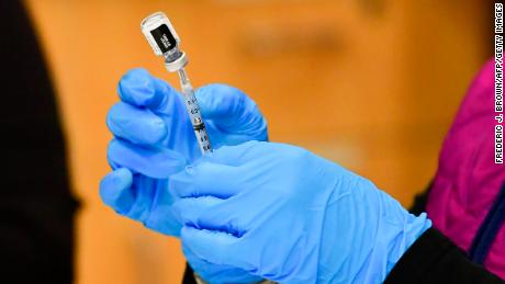 Registered Nurse Morgan James loads a syringe with a dose of the Pfizer Covid-19 vaccine at the Blood Bank of Alaska in Anchorage on March 19, 2021. - Alaska became the first state in the country last week to open vaccination access to everyone over the age of 16 and has fully vaccinated 16 percent of the state&#39;s population, the highest rate in the country. (Photo by Frederic J. BROWN / AFP) (Photo by FREDERIC J. BROWN/AFP via Getty Images)