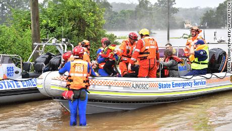 A family of four is evacuated from a flooded property at Upper Colo in north western Sydney, New South Wales on March 23. 