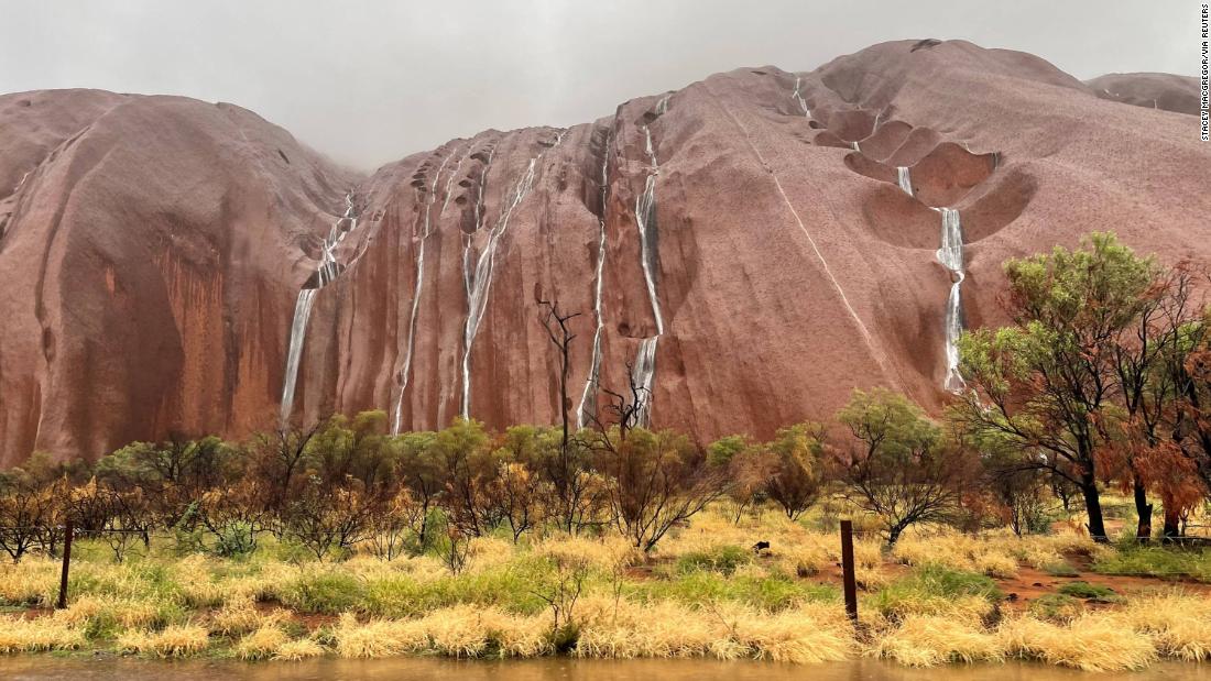 Water cascades down Uluru after heavy rains hit Northern Australia