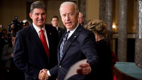 Sen. Joe Manchin, D-W.V., talks with then Vice President Joe Biden who conducted a mock swearing in ceremony in the Old Senate Chamber.