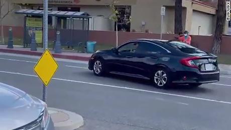 Authorities are investigating a possible hate crime after a man recklessly drove through a crosswalk during a &#39;Stop Asian Hate&#39; rally