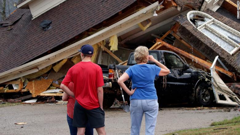 Residents survey damage to homes in the Eagle Point neighborhood after a tornado touched down south of Birmingham, Alabama, on March 25.