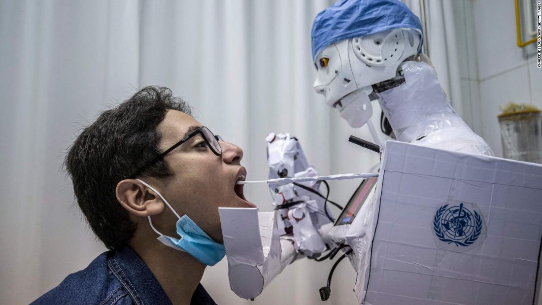 A remote-controlled robot takes a throat swab at a hospital in Tanta, Egypt, on March 20. The robot prototype is part of a project to assist physicians in testing patients for Covid-19.