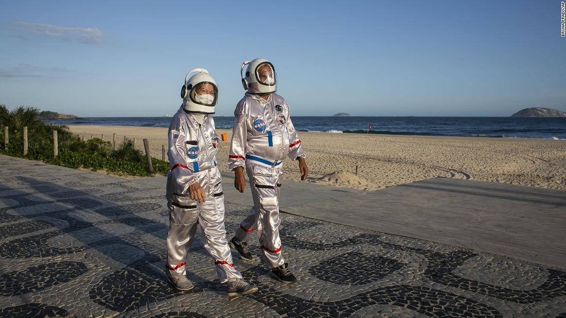 Tercio Galdino and his wife, Alicea, wear astronaut costumes to protect themselves from Covid-19 as they walk along the Ipanema Beach in Rio de Janeiro on March 20.