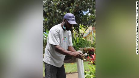 A contractor for CARE International fits taps onto new water pipes as part of the NGO&#39;s efforts to construct hand-washing facilities.
