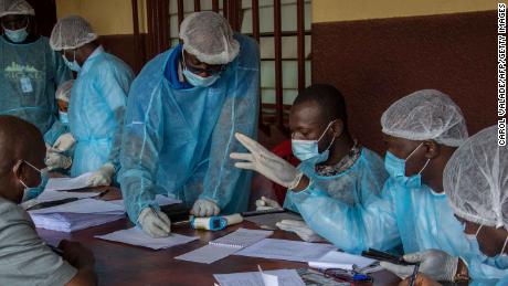 Health workers from the Guinean Ministry of Health prepare forms to register medical staff ahead of their anti-ebola vaccines at the N'zerekore Hospital.