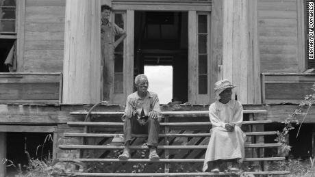 An ex-slave and his wife on the steps of a decaying plantation house in Greene County, Georgia. Many Black Southerners saw their rights gradually eroded in the late 1800s.