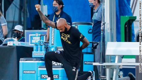  Head coach Thierry Henry of Montreal Impact takes a knee in support of the Black Lives Matter movement prior to a Group C match against Toronto FC as part of the MLS Is Back Tournament at ESPN Wide World of Sports Complex on July 16, 2020 in Reunion, Florida.