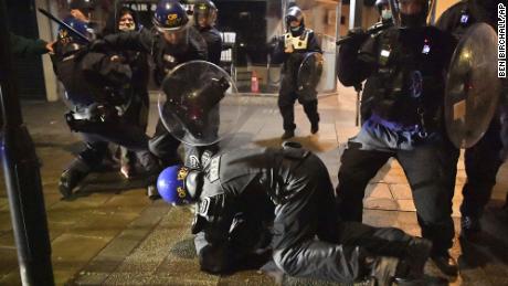 Police officers detain a man as they move in on demonstrators during the &quot;Kill The Bill&quot; protest in Bristol.